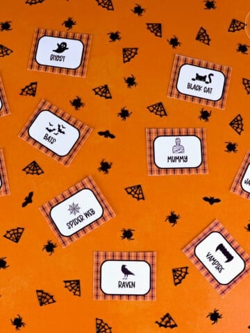 charades cards on orange background with black confetti