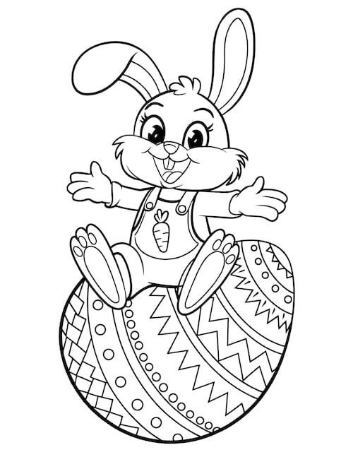 rabbit in overalls sitting on Easter egg