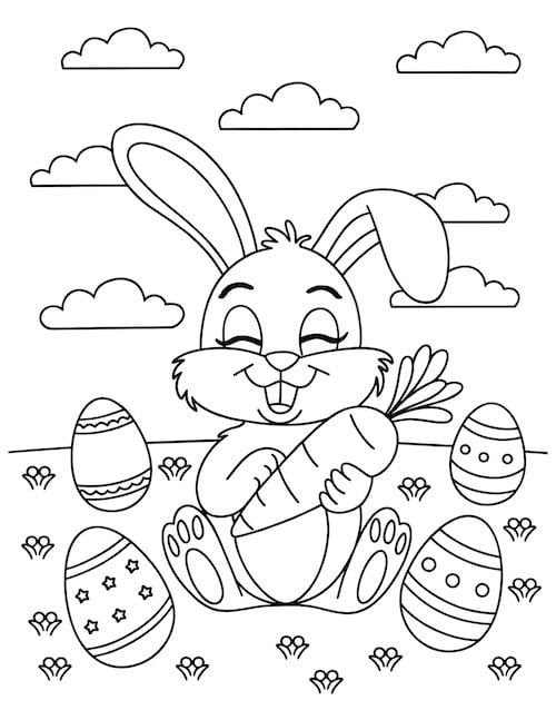 rabbit holding carrot in a field with eggs