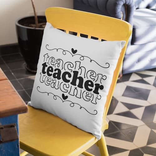 triple stacked teacher word on pillow