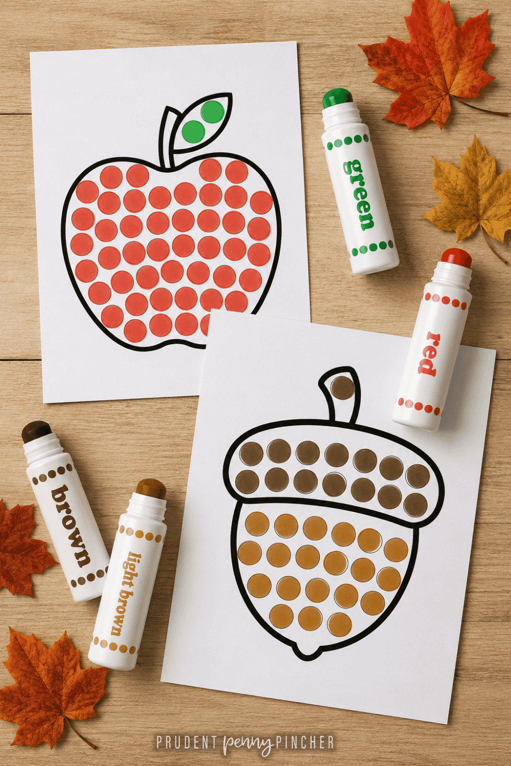apple and acorn worksheet, dot markers, and autumn leaves on a wood table