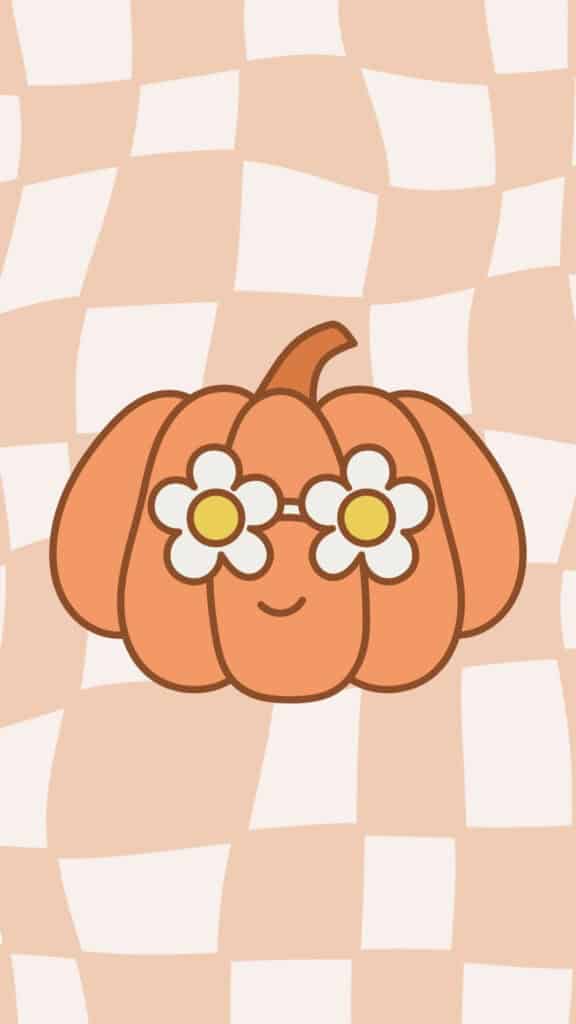 Smiling pumpkin wearing daisy glasses on a peach checkerboard