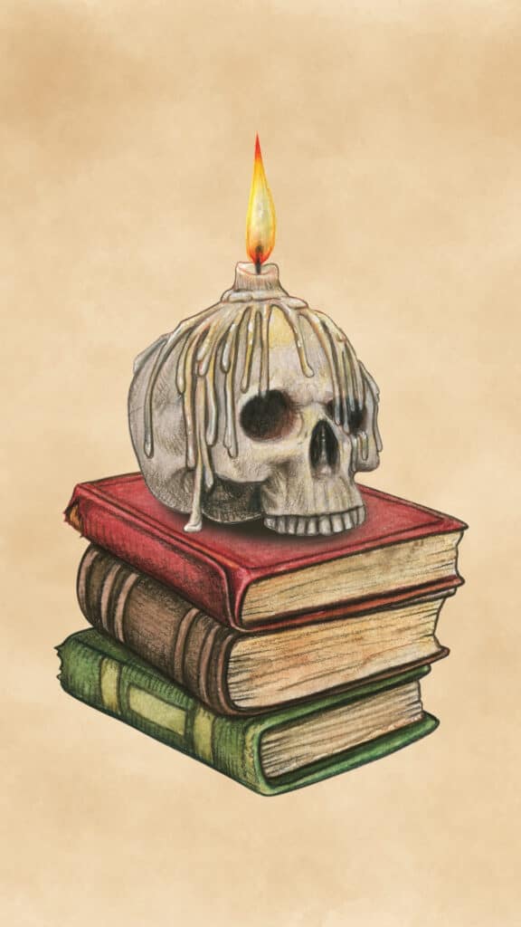 Vintage skull candle resting on a stack of old books