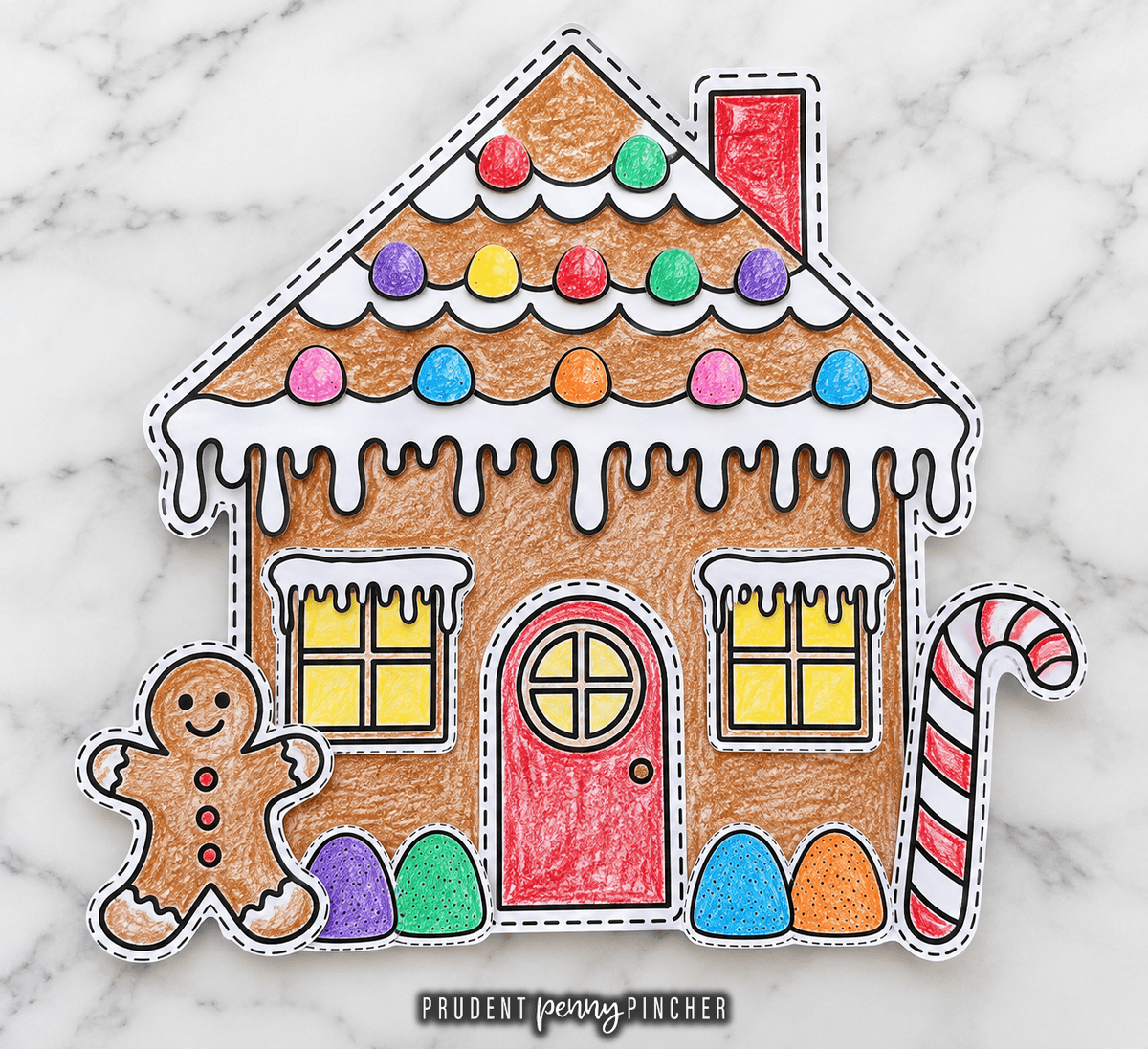 Completed craft colored with crayons and decorated with windows, a door, candy canes, gumdrops, and a gingerbread person.